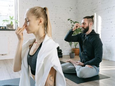 A calm, focused man breathing deeply before starting his exercise routine.