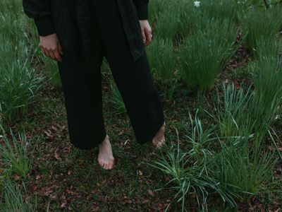 Close-up on a person's feet, firmly planted on the ground to show balance.